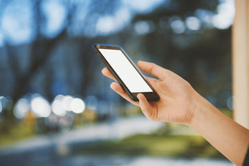 Girl with a smart phone in the city in a sunny day