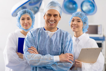 Merry surgical team in operating room