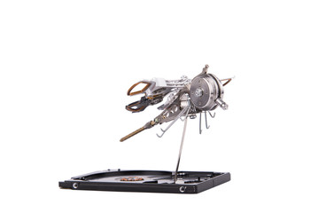 Isolated metal dragonfly made by hand from parts of old hard drive, steampunk, white background