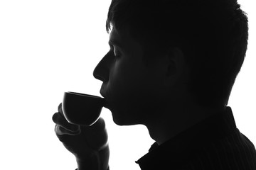 silhouette of a man drinking coffee