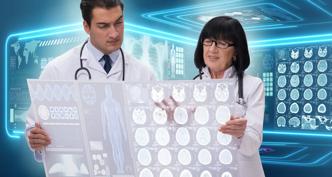 Woman and man doctor looking at MRI scan image