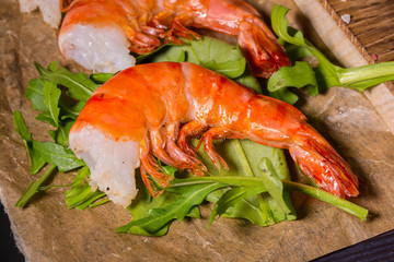 The royal shrimps fried on coals with leaves of arugula and a lime