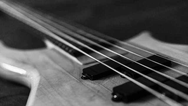 Black and white picture of a 5 string bass guitar
