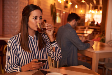 Millennial looking dreamily while drinking tea