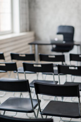 Blur Class room chair and table with white board and projector screen. white black colour concept.