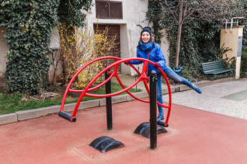 Fototapeta premium Portrait of young pretty woman having fun on swing in autumn park