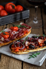 Tapas on crusty bread with red wine