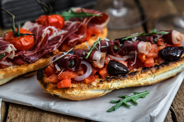 Smoked goose breast on crusty bread with tomato