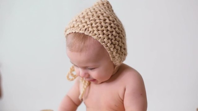 baby hat-knitting naked and smiling