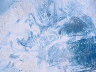 Abstract watercolor cement plaster wall background. Spots of blue paint on a rough structure texture.