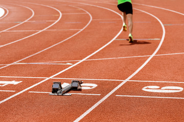 Male athlete running at the stadium