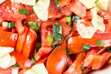 Closeup macro sliced tomato and onions salad on the table