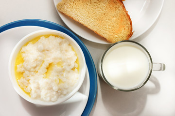 Healthy food - milk rice porridge with milk in a glass and toast (bread) Top view.