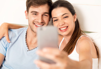 Couple on bed making selfies