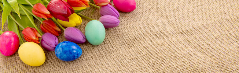 Obraz na płótnie Canvas Spring tulips with colorful easter eggs.
