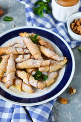 Sandwich rolls with cinnamon and sugar on a concrete background