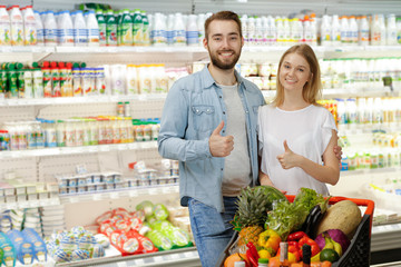 Happy couple doing groceries