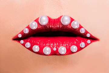 Beautiful red female lips with pearls.