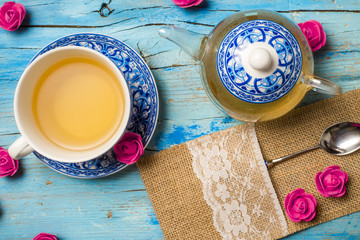 Transparent teapot and cup of tea