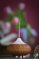 Aroma oil diffuser on blurred background