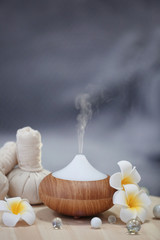 Fototapeta na wymiar Spa concept. Aroma oil diffuser on table against blurred background