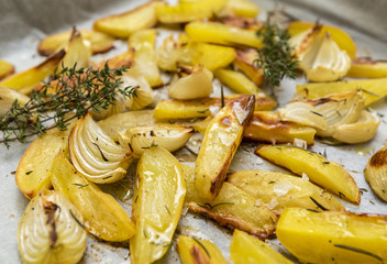 Home made baked potatoes with onion, herbs, pepper and sea salt
