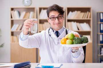 Doctor in dieting concept with fruits and vegetables