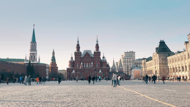 Tourists walking on the Red Square near the Kremlin and GUM department store