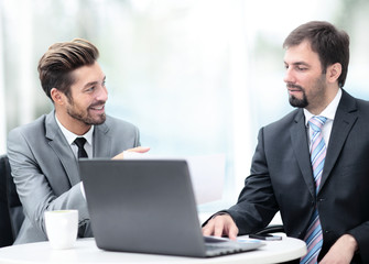 Fototapeta premium Two handsome businessmen working together on a project in the of