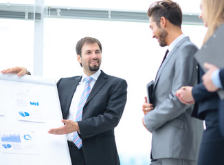 Mature man making a business presentation to a group