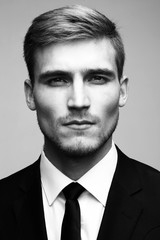 Black and white close-up portrait of a successful handsome busin
