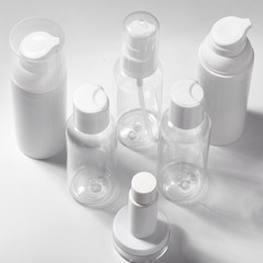 White cosmetic bottles on white background. Wellness, spa and body care bottles collection. Beauty treatment