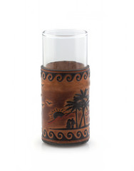 Glass in decorative leather case on white background