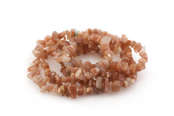 Natural stones, beads made of sunny stone on a white background