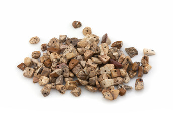Natural stones crumb jasper sand for decoration on a white background. Isolated