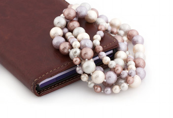 Pearls of a mallorca on a leather mobile phone case on a white background