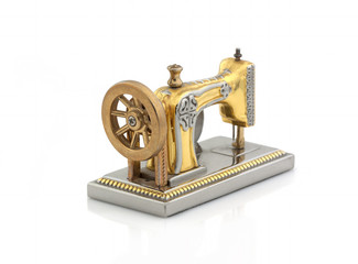 Decorative clock in the form of an old sewing machine on a white