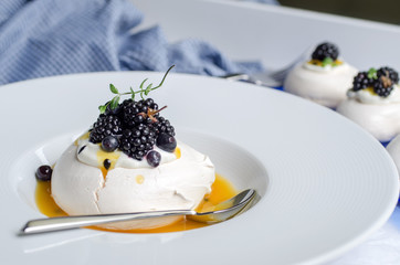 Pavlova dessert with passion fruit sauce