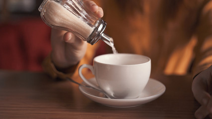 white cup with drink and sugar bowl