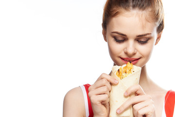 fast food in the hands of a woman on a light background