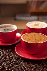 A cup of cappuccino on coffee beans