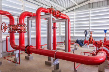 Industrial fire pump station for water sprinkler piping and fire alarm control system. Pipelines, water pump, valves, manometers. - obrazy, fototapety, plakaty