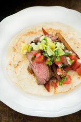 Beef fajitas served over tortilla