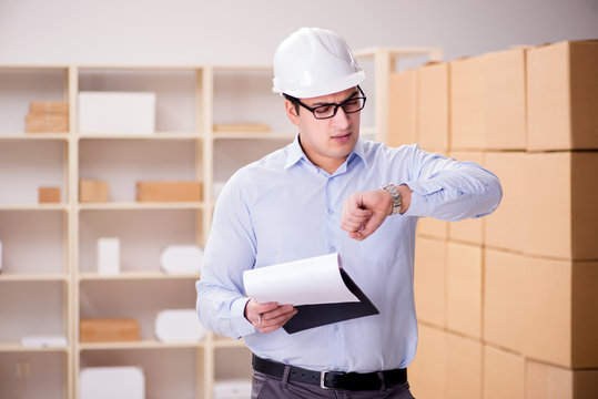 Young Worker In The Postal Office Dealing With Parcels