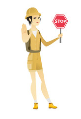 Asian traveler holding stop road sign.
