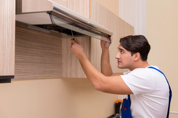 Young man working with kitchen equipment