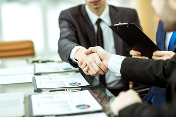 handshake business partners after discussion of the financial agreement