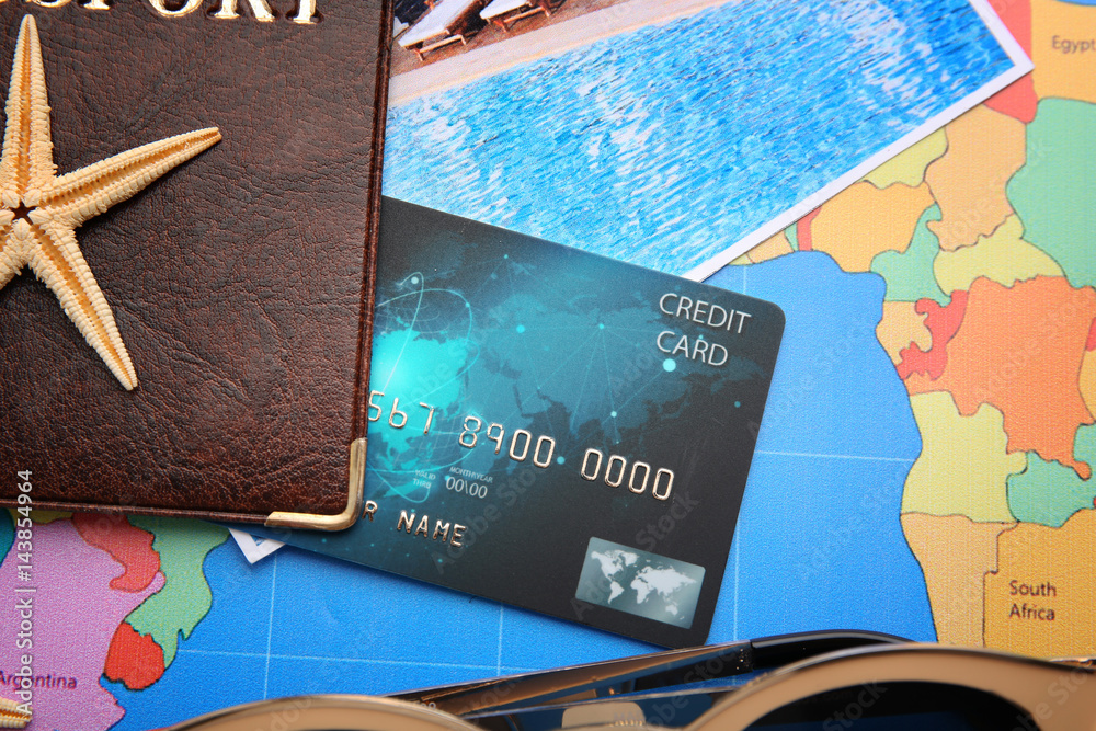 Poster Credit card with passport on world map background