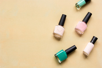 Obraz premium set for nail polish on orange table background top view mock up