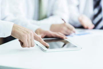 business team using digital tablet, working with the financial schedule of the company's development